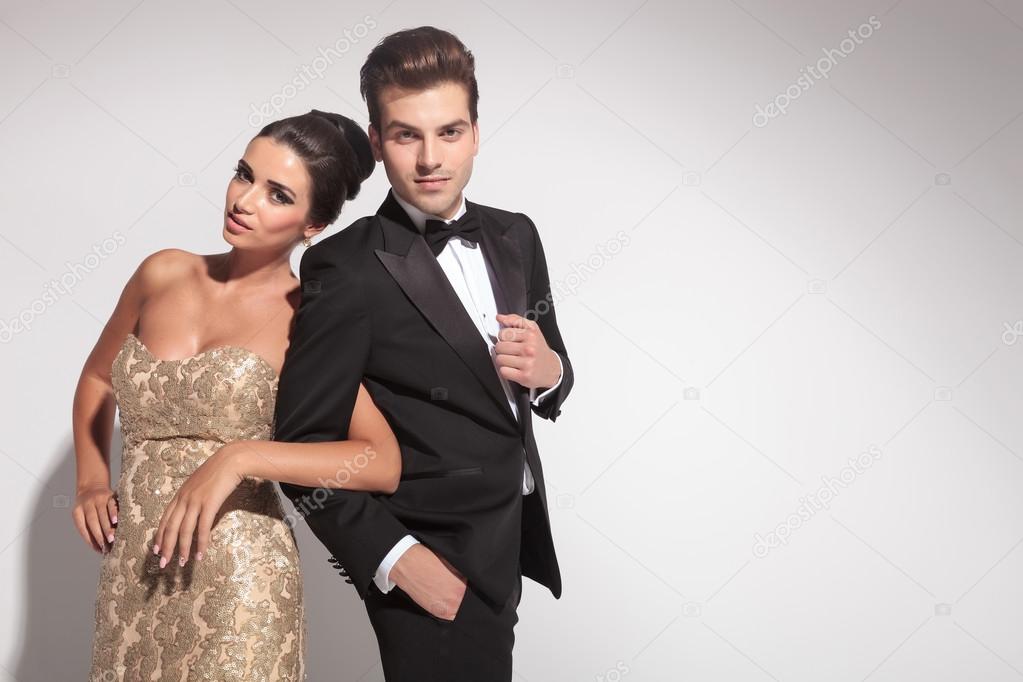 Elegant couple posing while holding arms