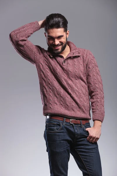 Young fashion man holding his thumb in his pocket — Stock Photo, Image