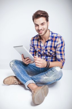 mutlu genç adam bir tablet pad bilgisayar holding