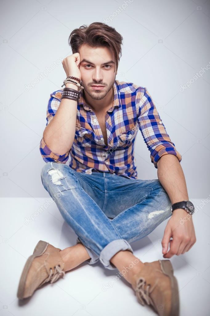 young fashion man relaxing his head on his hand