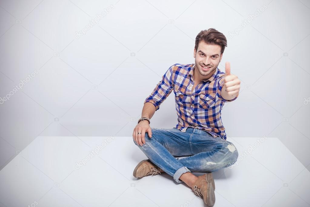 fashion man smiling and showing the thumbs up gesture 