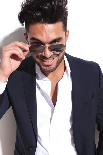 Handsome business man taking of his sunglasses — Stock Photo, Image