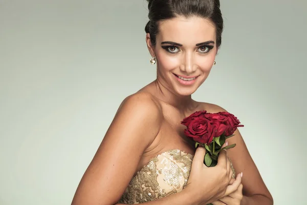 Mulher sorridente segurando rosas — Fotografia de Stock