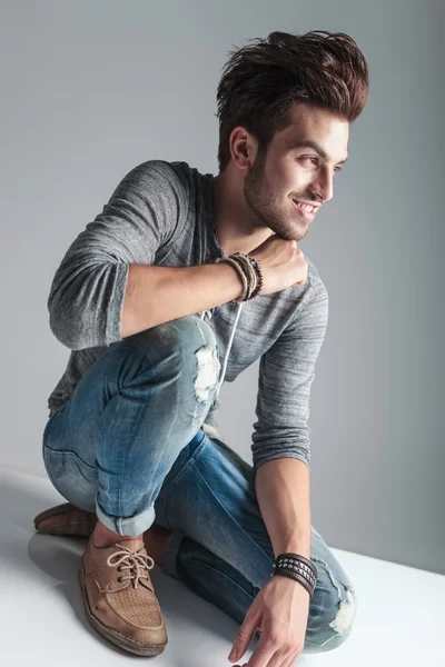 Fashion man relaxing on the floor while smiling — Stock Photo, Image