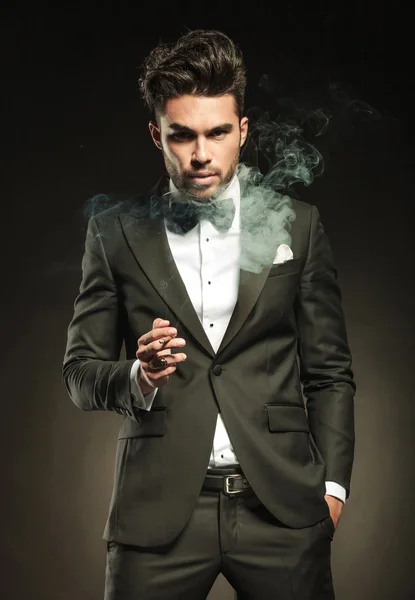 Elegant business man holding a cigarette in his right hand. — Stock Photo, Image