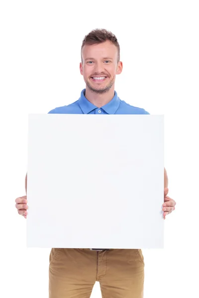 Casual young man shows his blank board — Stock Photo, Image