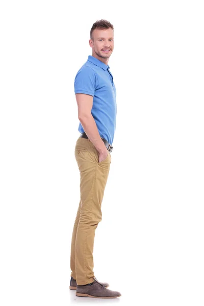 Side of casual young man with hand in pocket — Stock Photo, Image