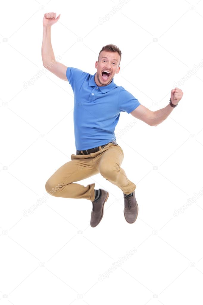 casual young man jumps in the air
