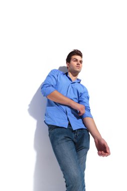 adam onun kol tamir ederken bir duvara yaslanmış. 