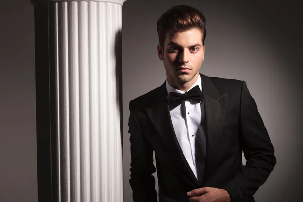 Elegant business man posing near studio background — Stock Photo, Image