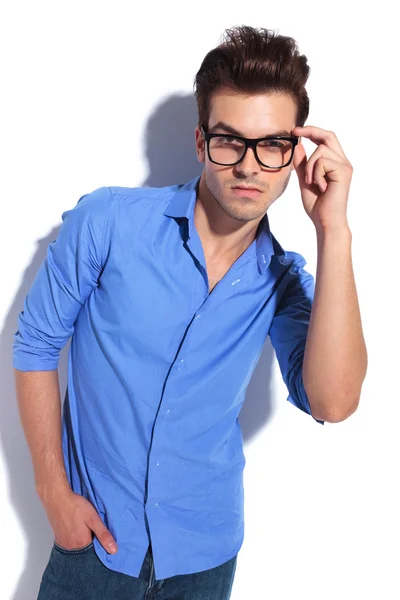 Business man fixing his glasses while looking at the camera — Stock Photo, Image