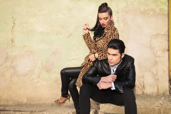 Man sitting while his girlfriend is playing with her hair — Stock Photo, Image