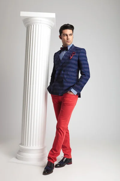 Fashion man posing near white column — Stock Photo, Image