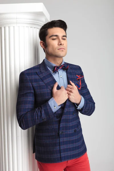 Young casual man fixing his jacket — Stock Photo, Image