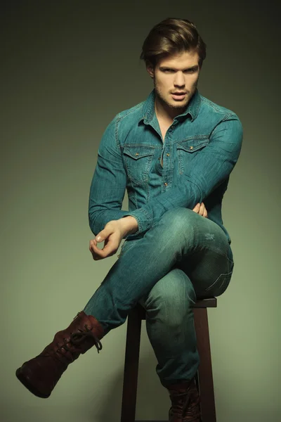 Fashion man resting on a stool — Stock Photo, Image