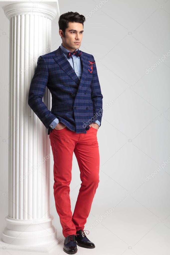 young fashion man leaning on a white column 