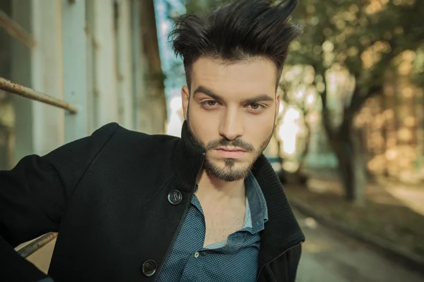 young fashion man posing on the street