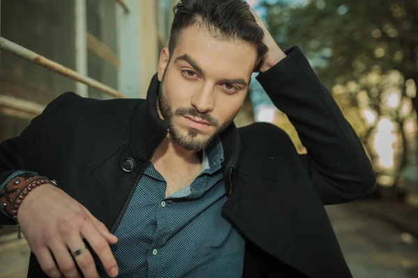 Young fashion man fixing his hair — Stock Photo, Image