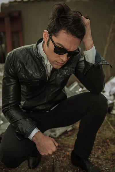 Young man looking down while sitting — Stock Photo, Image