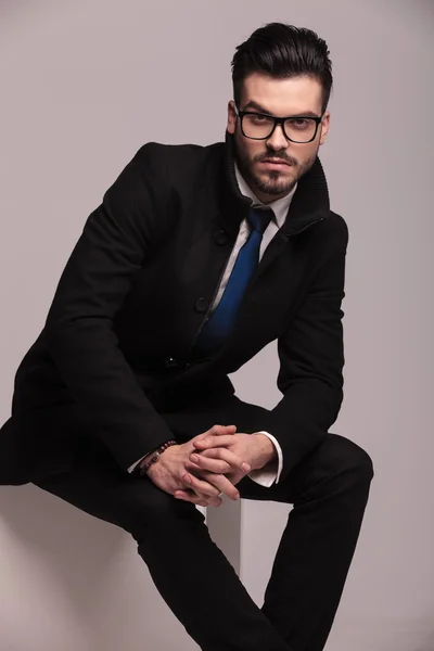 Elegant business man sitting with his hands together — Stock Photo, Image