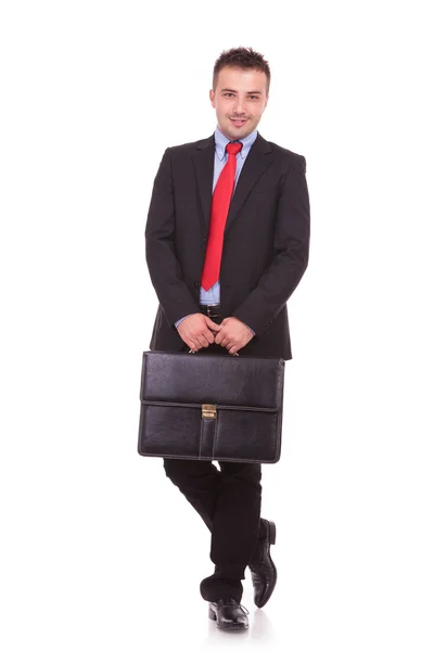 Business man holding a black leather briefcase — Stock Photo, Image