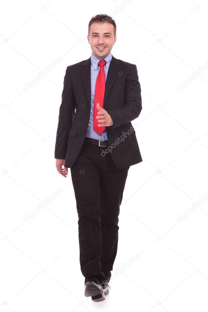 Happy business man walking on white studio background 