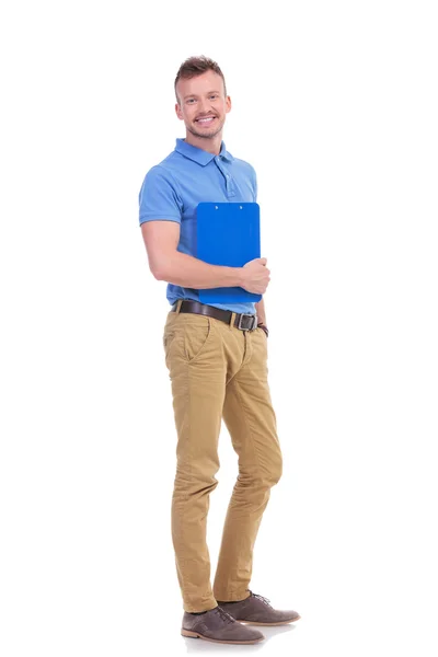 Young casual man holds his clipboard — Stock Photo, Image