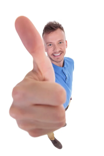 Young man shows thumb up sign — Stock Photo, Image