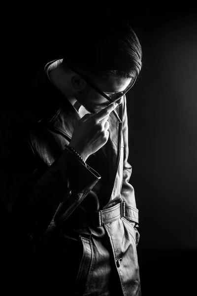 Fashion man looking down while enjoying a cigarette — Stock Photo, Image