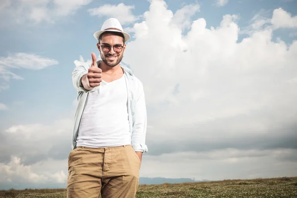 Attractive young fashion man showing the thumbs up gesture — Stock Photo, Image