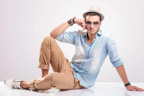 Young casual man sitting on the floor — Stock Photo, Image