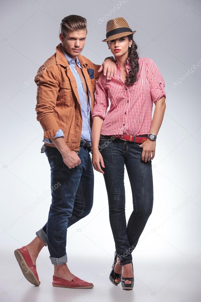 fashion couple posing on grey studio background