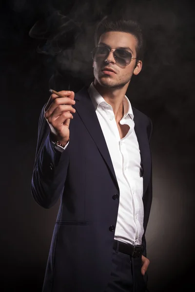 Elegant business man enjoying a cigarette. — Stock Photo, Image