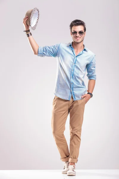 Fashion man greeting you while taking off his hat — Stock Photo, Image