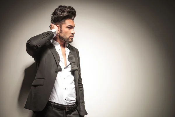 Handsome young business man fixing his hair — Stock Photo, Image