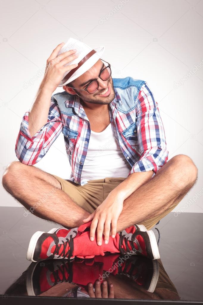 Casual fashion man sitting with his legs crossed 