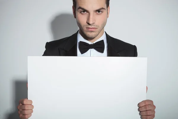 Handsome business man holding a white board — Stock Photo, Image