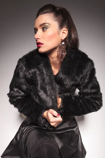 Casual fashion woman closing her fur jacket Royalty Free Stock Images