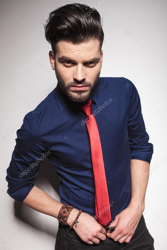 business man holding both hands on his belt