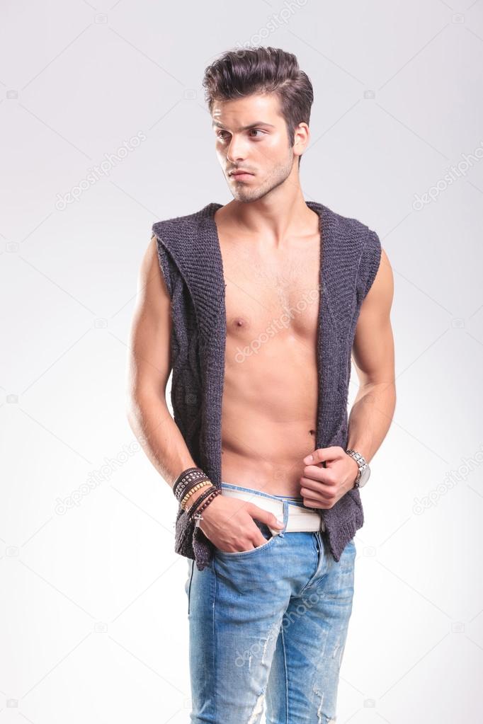 sexy young casual man posing in a knit vest