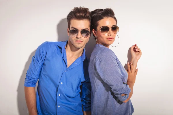 Pareja casual posando contra una pared greay . —  Fotos de Stock