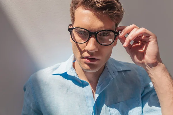 Handsome casual man taking off his glasses. — Stock Photo, Image