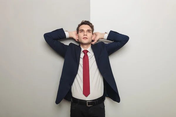 Young business man holding both hand to his head — Stock Photo, Image
