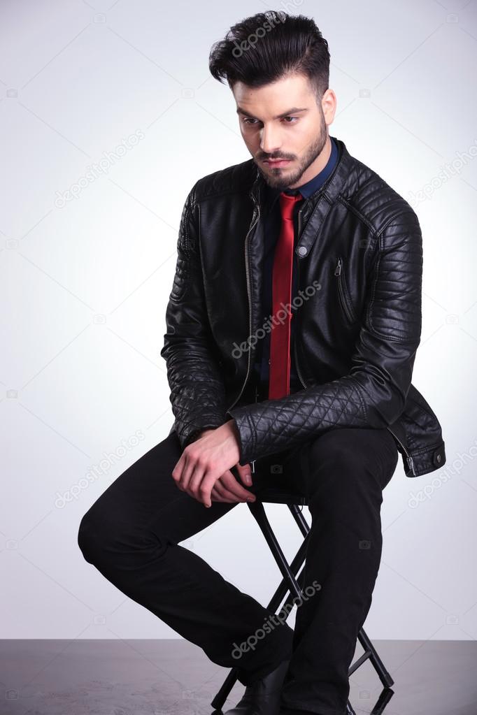 Young casual business man resting on a chair.