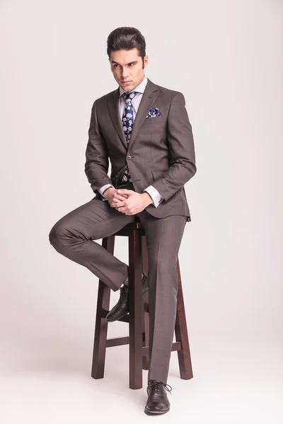 Handsome young business man sitting on a chair — Stock Photo, Image