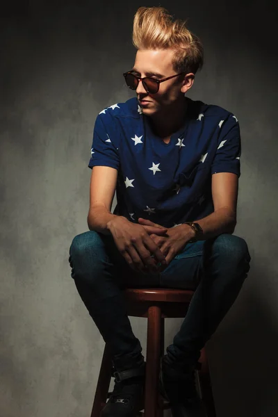 Young fashion man is resting on a stool — Stock Photo, Image