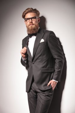 Young business man leaning on a wall while
