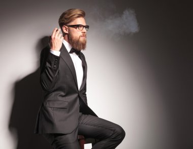blond business man resting on a stool 