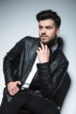 business man sitting on a stool while looking up