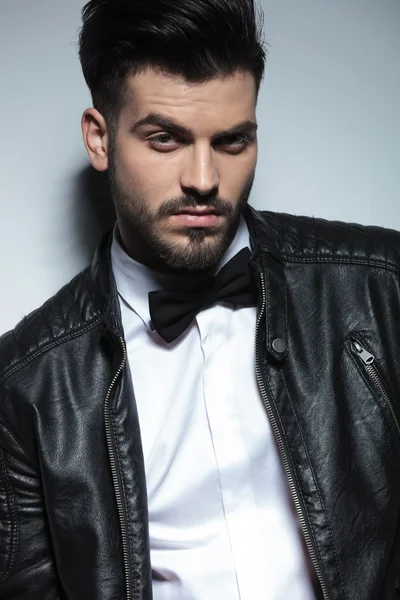 Business man wearing a leather jacket and a bowtie. — Stock Photo, Image